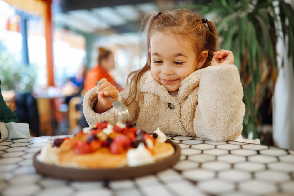 girl eating pancakes